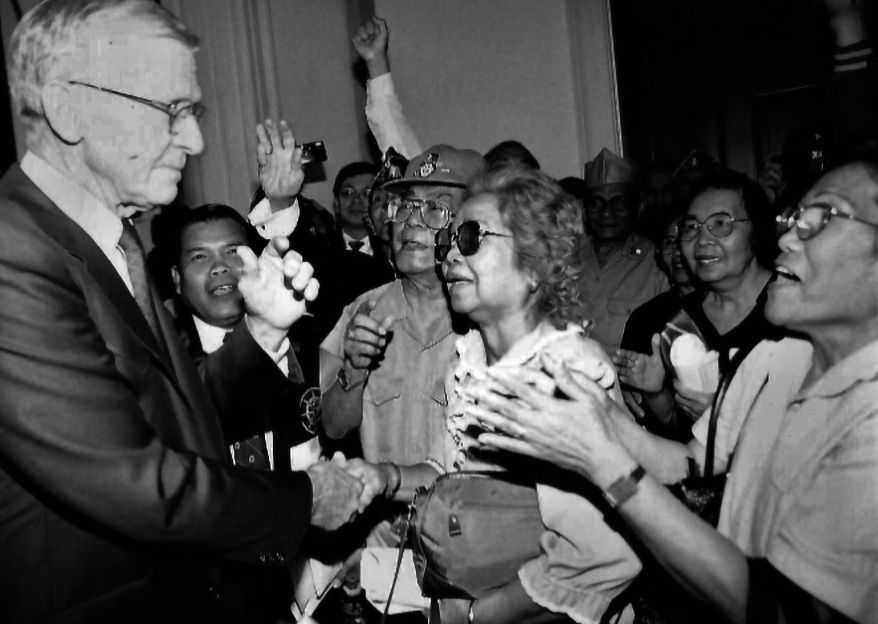 Bob Stump shaking hands with veterans. 